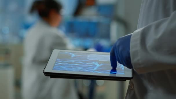 Close up of researcher using tablet, pointing, analysing DNA informations — Stock Video