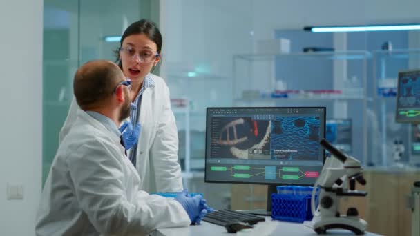 Equipe cientista médico realizando experimentos de DNA olhando em computador — Vídeo de Stock