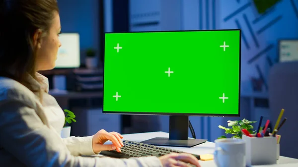 Freelancer working in front of green screen display