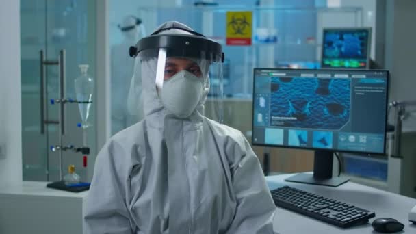 Overworked woman chemist in coverall looking tired at camera — Stock Video