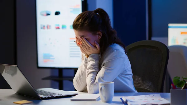 Exhausted freelancer sleeping in front of laptop working