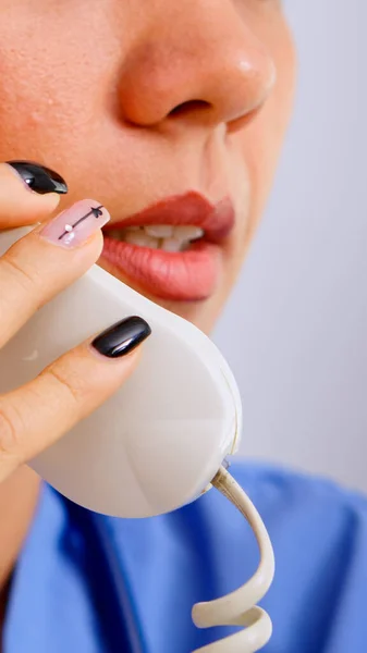 Close up of medical receptionist answering phone calls