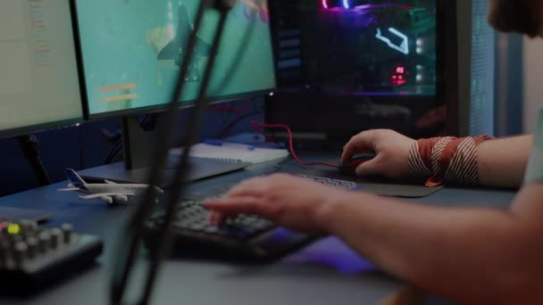 Close up of player hands using RGB keyboard in gaming home studio — Stock video