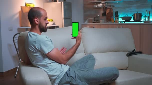 Hombre enfocado hablando con sus amigos en el teléfono inteligente con pantalla verde simulada croma pantalla clave — Vídeos de Stock