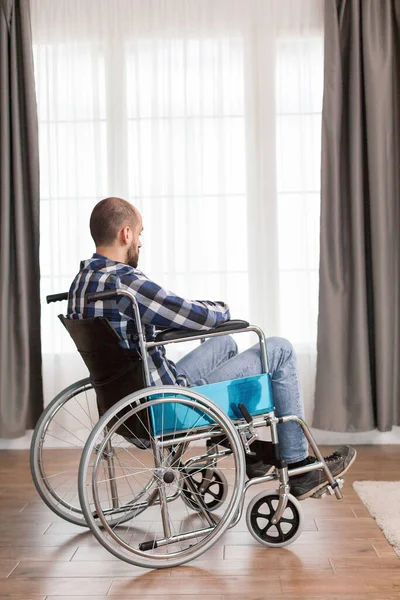 Man in wheelchair living alone