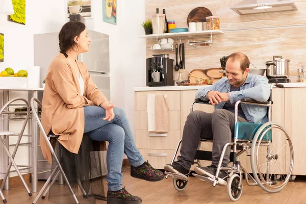 Woman looking at disabled husband