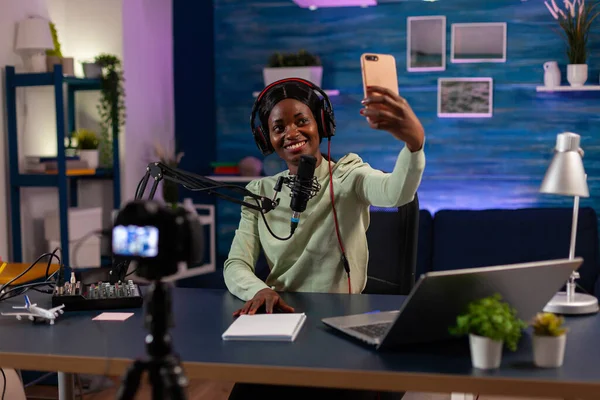 African woman using smartphone to take photo