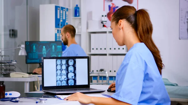 Doctor assistant analyzing skull brain x-ray tommography — Stock Photo, Image