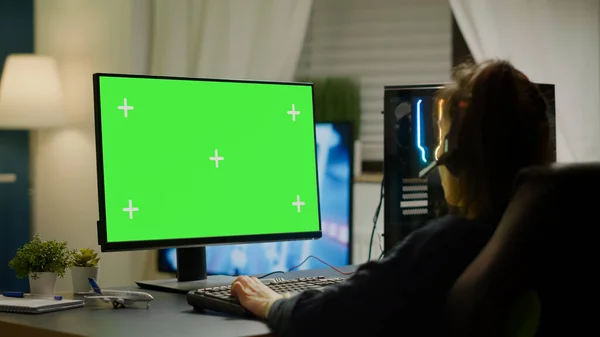 Pro играет в виртуальную видеоигру на компьютере с зеленым экраном — стоковое фото
