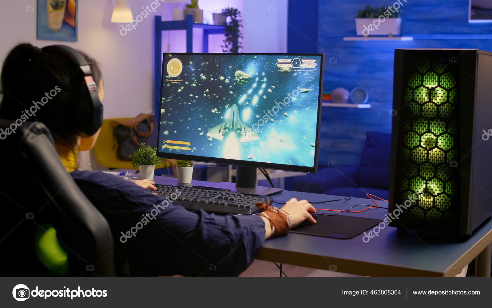 Adult using keyboard and mousepad to play video games on computer. Gamer  playing online game in