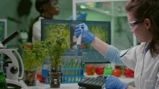 Bioloog onderzoeker met behulp van micropipette zetten genetische oplossing in reageerbuis — Stockvideo