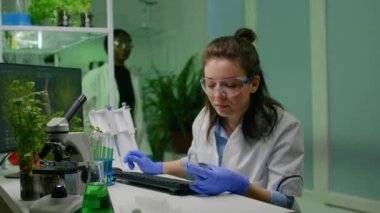 Kimyager bilim adamı mikro pipetle test tüpünden DNA çözeltisi alıyor.