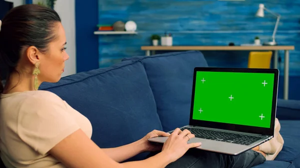 Tracking shot of freelencer woman typing on mock up green screen chroma key laptop computer