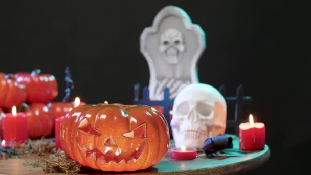 Halloween decorated table with a flashing red light on the black background — Stock Video