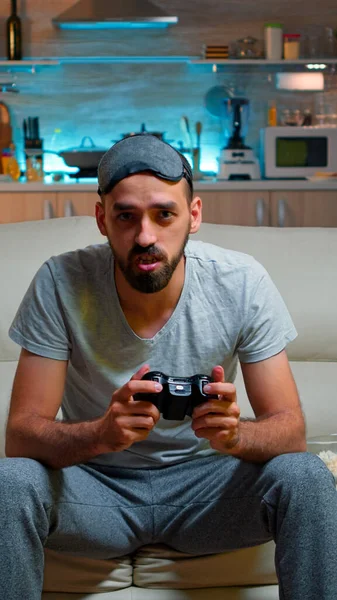 Focused man holding joystick while sitting in front of television — Stock Photo, Image