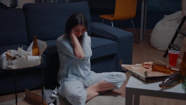Traurige hoffnungslose junge Frau sitzt allein zu Hause und fühlt sich verzweifelt — Stockvideo