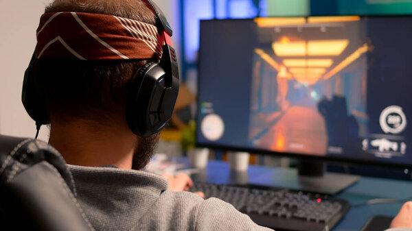 Pro gamer playing on powerful computer shooter video game