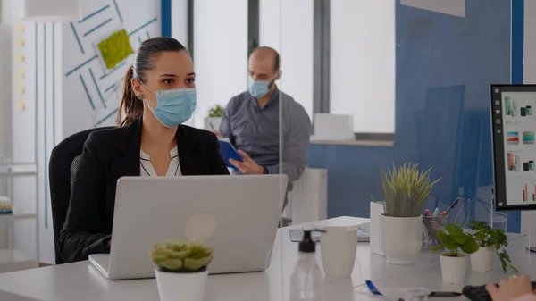 Business team with medical face masks working together in startup company office — Stock Photo, Image