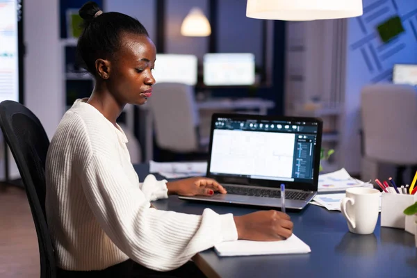 African architect taking notest on notebook working on project — Stock Photo, Image