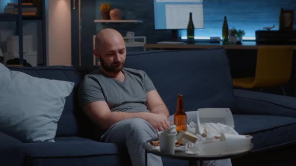 Deprimido apático preocupado hombre sentado en el sofá llorando mirando a la cámara — Vídeos de Stock