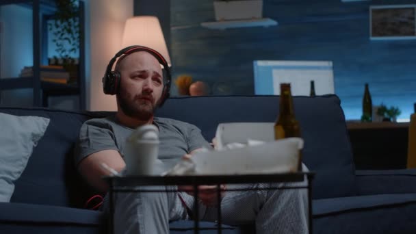 Hopeless depressed man listening sad music at headphones — Stock Video
