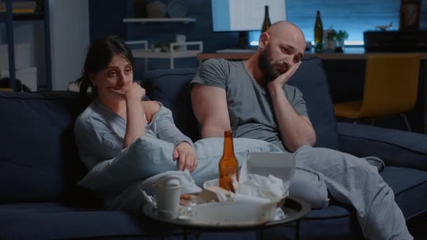Καταθλιπτικό, απογοητευμένο νεαρό ζευγάρι που κάθεται στον καναπέ και υποφέρει από αϋπνία — Αρχείο Βίντεο