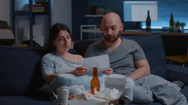 Young stressed married couple starting to cry reading bad news — Stock Video