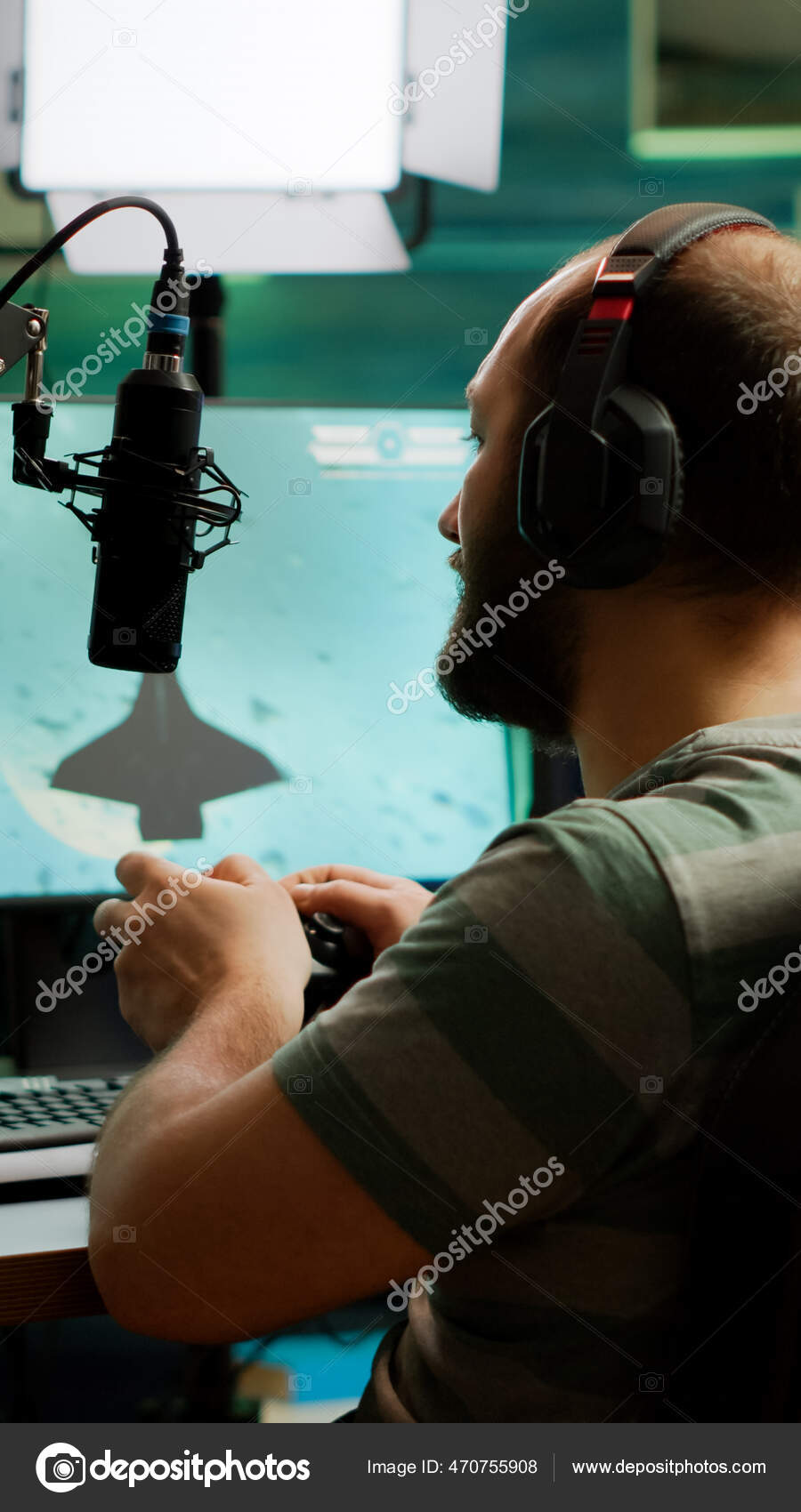 Man streamer playing space shooter video games using controller Stock Photo by ©DragosCondreaW 470755908