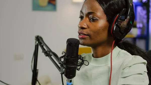 Black vlogger on air during podcast channel using mixer checking sound — Stock fotografie