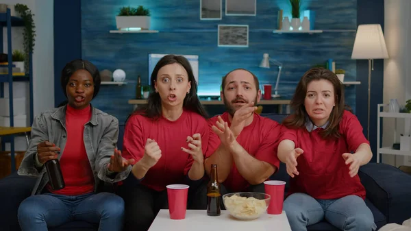 Mutlu çoklu etnik arkadaşlar futbol takımının kazanmasından sonra birlikte tezahürat yapıyorlar.