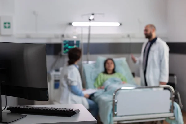 Kranker Patient liegt mit nasalem Sauerstoffschlauch im Bett und diskutiert mit Ärzten — Stockfoto