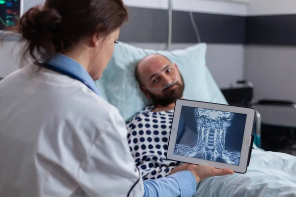 Spécialiste praticien femme vérifier la radiographie osseuse à l'aide d'un ordinateur tablette — Photo