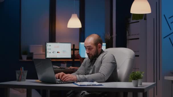 Überarbeiteter Geschäftsmann tippt Management-Strategie auf Laptop in Startup-Firma — Stockvideo