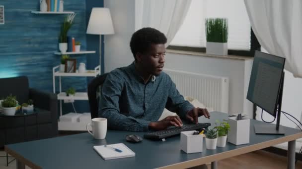 Black man computer user working from home in cozy flat — Stock Video