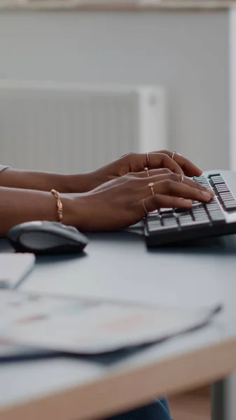 Close-up of teenager with dark skin hands on keyboard typing email on computer — Stock Photo, Image