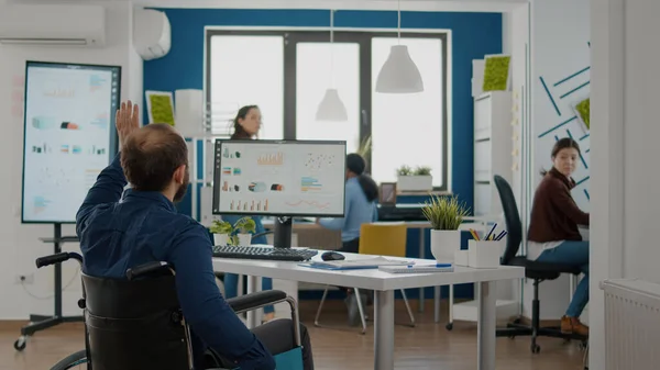 Entrepreneur handicapé venant dans le bureau de démarrage, collègues accueillant — Photo