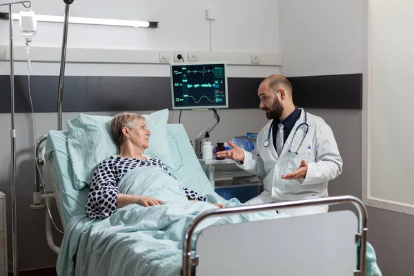 Senior woman laying in bed inhale and exhale with help from oxygen tube