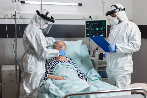 Medical team in clinic wearing coverall ppe and face shield