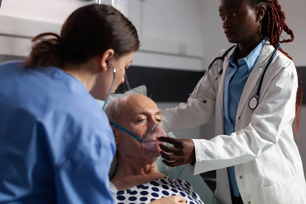 Zijaanzicht van senior patiënt ademhaling bijgestaan door respiratoire buis — Stockfoto