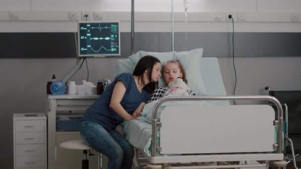 Moeder legt medicatiebehandeling uit aan zieke dochter na een medische ingreep — Stockvideo
