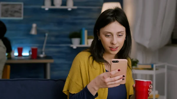 Mooie vrouw met telefoon in de hand lezen bericht op internet — Stockfoto