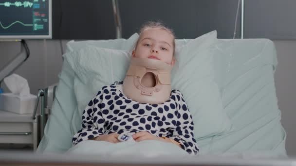 入院中の小さな子供の肖像-ベッドで休んでいる医療首の首の襟 — ストック動画