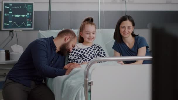 Familia viendo la película de dibujos animados en la televisión en la sala de hospital mientras espera por la experiencia de la enfermedad médica — Vídeos de Stock