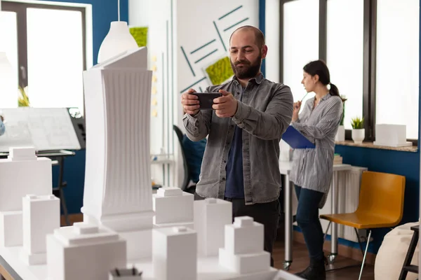 Proje için akıllı telefona bakan tasarımcı