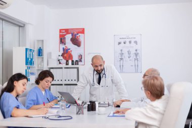 Steteskoplu terapist doktor, tıbbi uzmanlığı tartışan sağlık tedavisini açıklıyor.