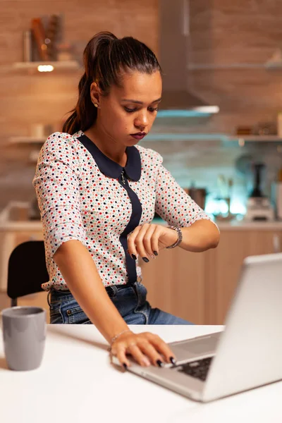 Exhausted businesswoman checking time