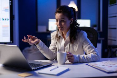 Gece geç saatlerde ekonomik istatistikleri analiz eden işkolik iş kadını