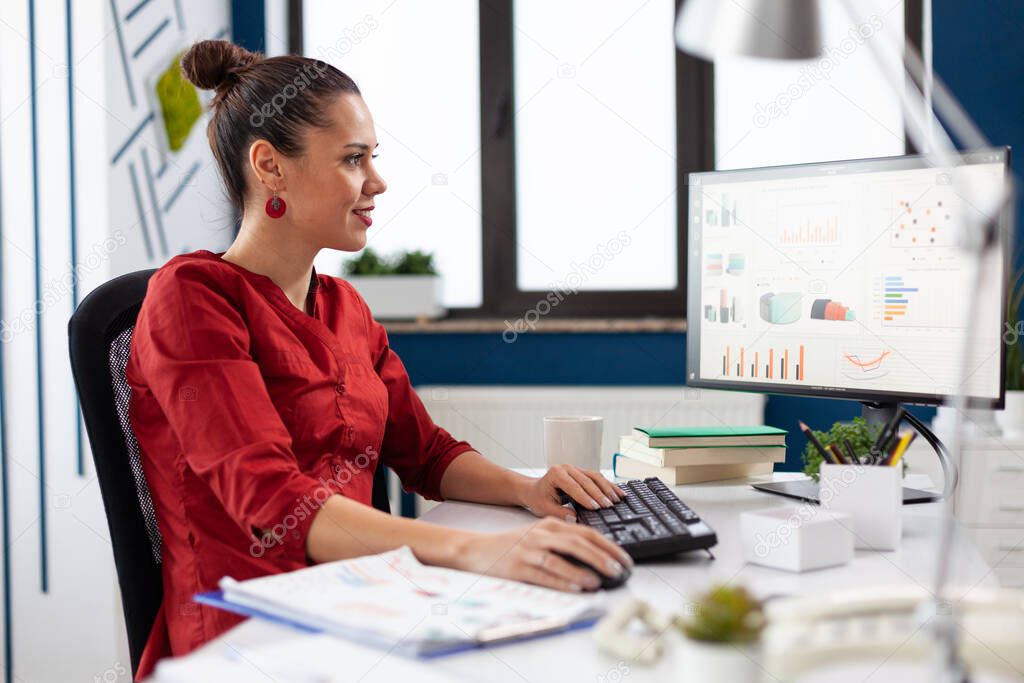 Successful businesswoman working on computer in company office