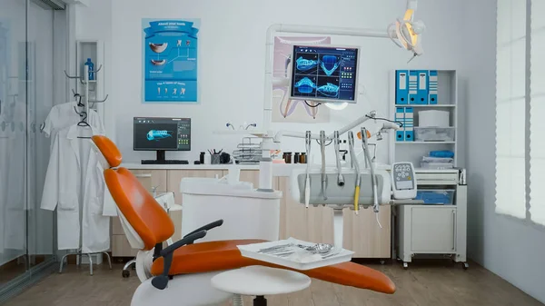 Увеличить съемку стоматологического кабинета ортодонта с изображениями зубного рентгена на мониторе — стоковое фото