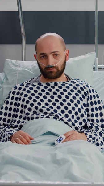 Potrait eines kranken Mannes, der im Bett ruht und auf Atembehandlung wartet — Stockfoto
